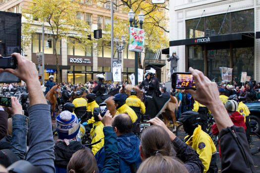 PORTLAND, OREGON - NOV 17: Spectactors taking pictures with camera phones of Police in Riot Gear in Downtown Portland, Oregon during Occupy Portland Protest November 17, 2011