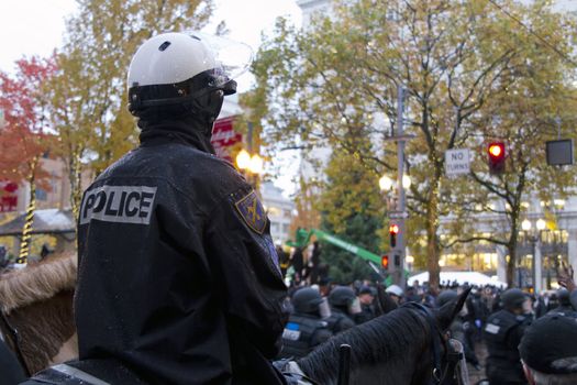 PORTLAND, OREGON - NOV 17: Mounted Police Watching over protestors in Downtown Portland, Oregon during a Occupy Portland protest on the first anniversary of Occupy Wall Street November 17, 2011