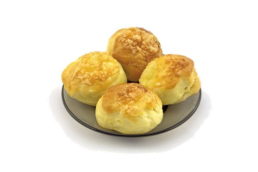 Four scones on a glass plate on white background