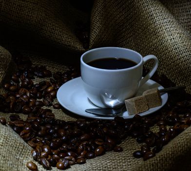 Coffee cup, beans and burlap. still life