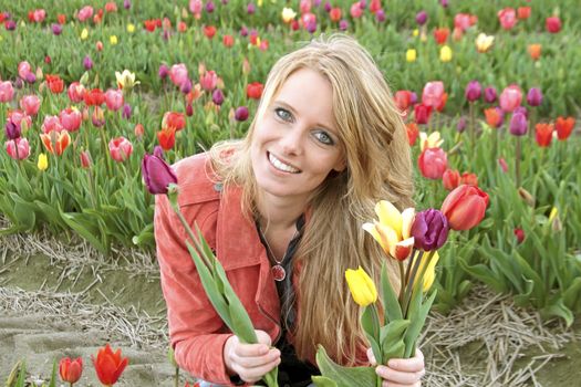 Dutch woman between the flower fields in the Netherlands