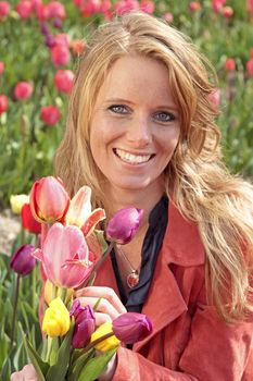 Dutch woman between the flower fields in the Netherlands