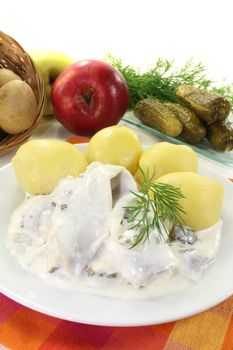 cream marinated herring with potatoes, cucumbers, apple and dill