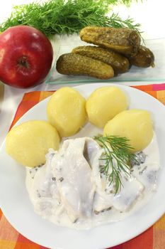 cream marinated herring with potatoes, apple and dill