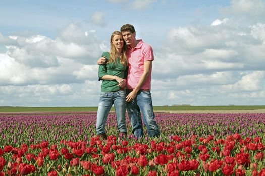 Young happy couple in the tulip fields from the Netherlands
