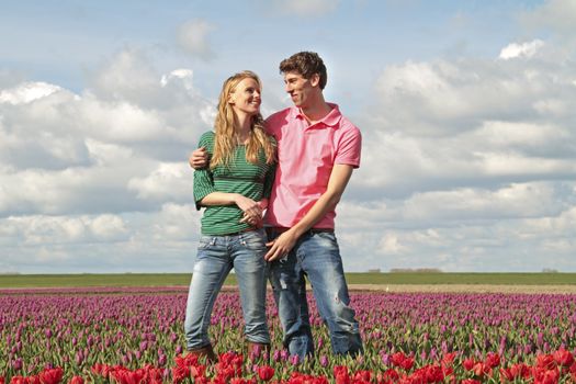 Young happy couple in the tulip fields from the Netherlands