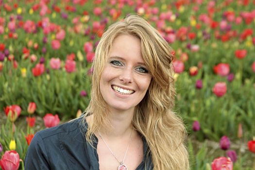 Dutch woman between the flower fields in the Netherlands