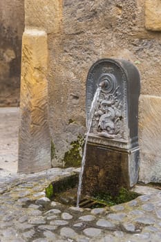 Small water fountain in French medieval village