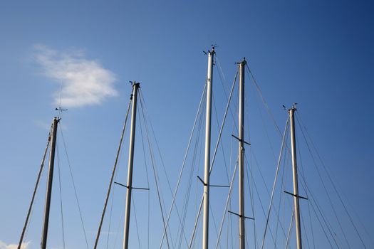 masts of yachting boats on a blue sky