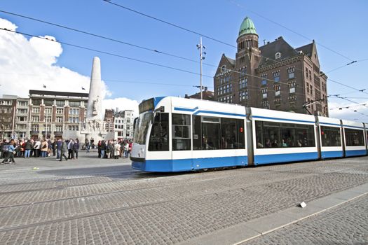 Tram driving at Dam square in Amsterdam the Netherlands