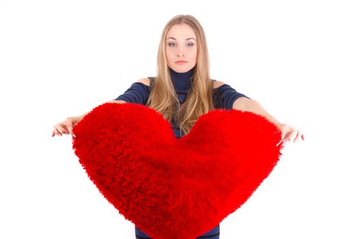 Young beautiful  girl  hugs a big soft heart. Feast of St. Valentine's Day.