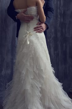 Bride and groom near the wooden house.