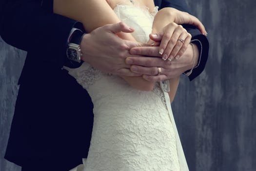 Bride and groom near the wooden house.