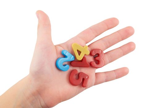 A small child's hand holding colorful plastic figures on an isolated white background