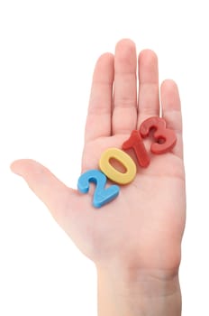 Child's hand holding plastic figures on an isolated white background