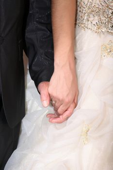 bride and groom at their wedding holding hands