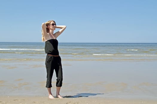 Beautiful woman relaxing at the beach from the north sea in the Netherlands