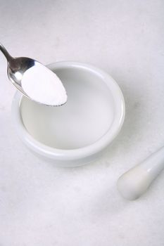 mortar pestle and  spoon with powder closeup