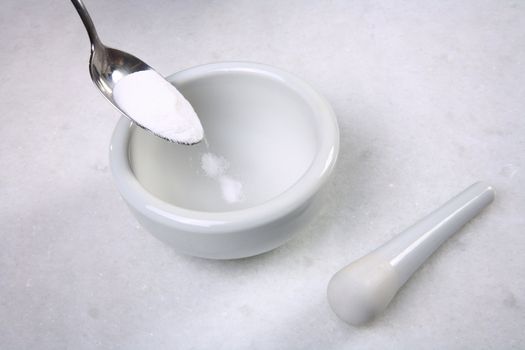 mortar pestle and  spoon with powder closeup