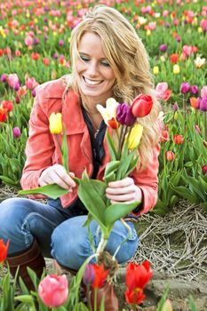 Beautiful young woman in the tulip fields in the Netherlands