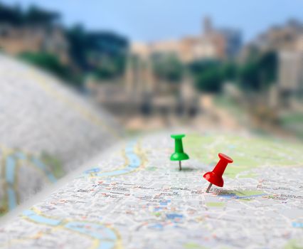 Push pins pointing planned travel destinations on tourist map, blurred background