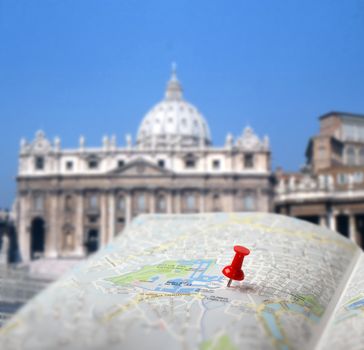 Push pin pointing St. Peter's church on Vatican Rome city map
