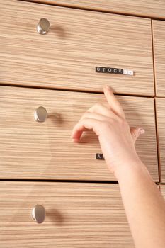 pharmacy stock drawer and a hand showing it