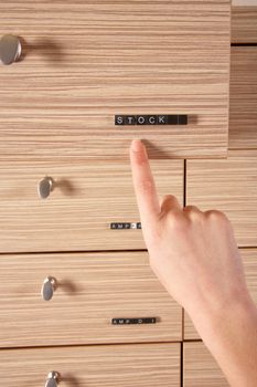 pharmacy stock drawer and a hand showing it