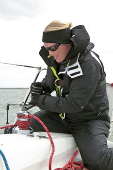 Woman in action during a sail competition on the IJsselmeer in the Netherlands