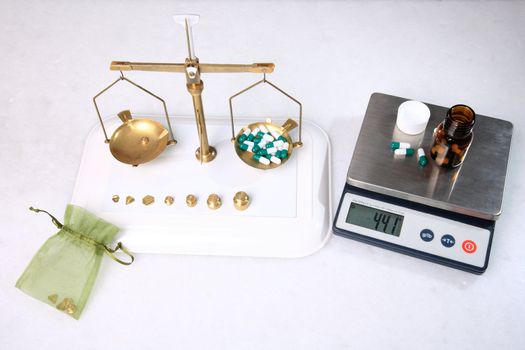 analog and digital pharmacy scales with pills