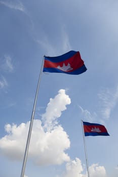Two Cambodian flags waving under blue sky in Phnom Penh Cambodia