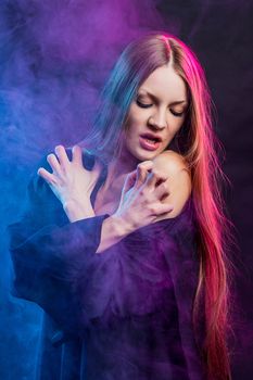 beautiful passionate girl in red and blue smoke