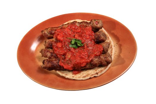 shish kebab with tomato served on a plate with pita