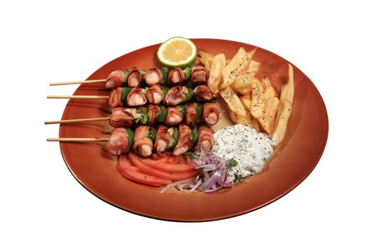 chicken skewers with beacon and green peppers served on a plate