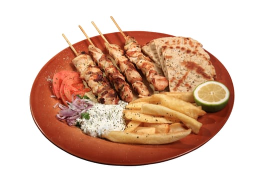 chicken skewers served on a plate with fries tzatziki and pita