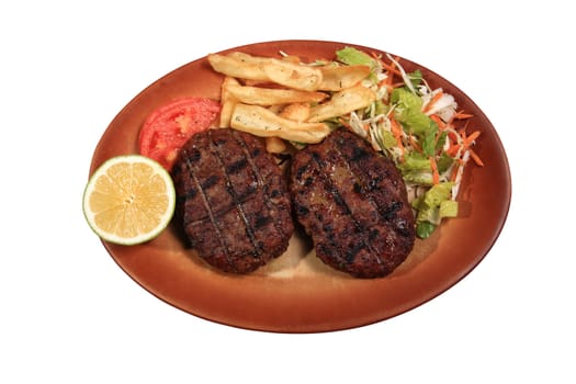 meat balls served with fries and vegetables on a plate