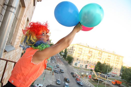 Young woman adventurer is going to fly with balloons over the city