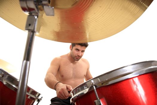 young male drummer isolated on a white background