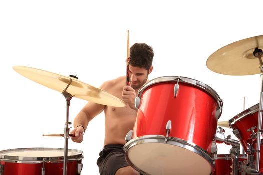 young male drummer isolated on a white background