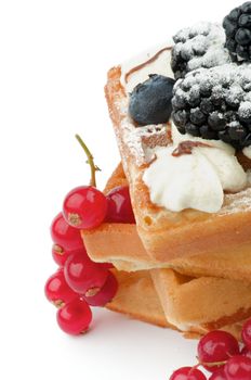 Stack of Delicious Belgian Waffle, Berries and Whipped Cream closeup on white background