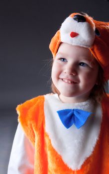 Little baby girl  dressed in a fox suit .Closeup