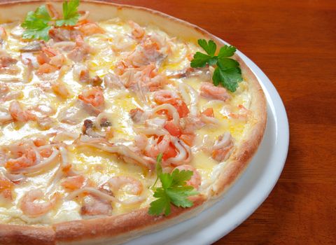 Tasty Italian pizza  on plate.Italian kitchen.seafoods,prawns