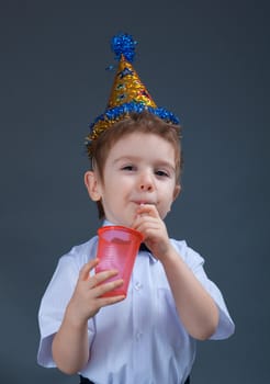 holiday Boy drinking juice isolated on white 