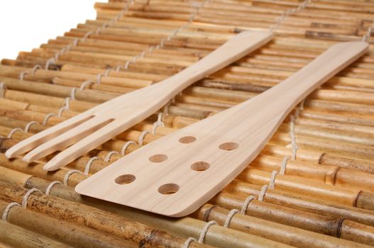 set of three wooden kitchenware on bamboo napkin