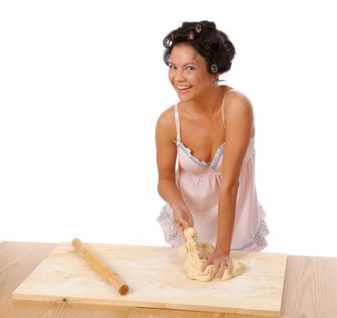  housewife mix dough on the wooden board.Studio, white background. 