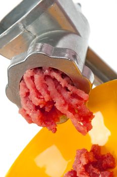 Meat grinder in action. Raw beef Studio, white background. 