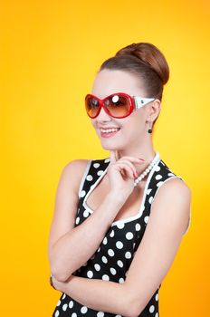 Girl in american 60s style in  polka dot dress 