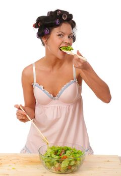 Pretty girl shuffle a salad .Studio, white background. 