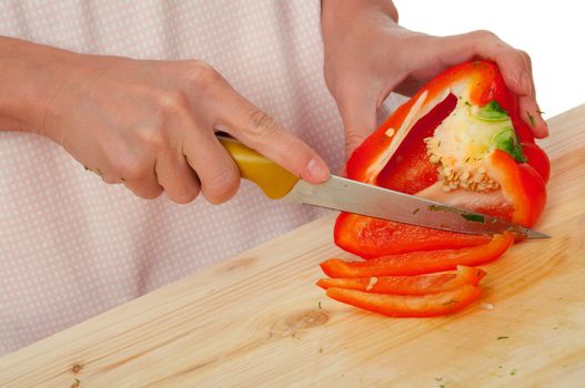 housewife preparing  paprika .Studio, white background. 