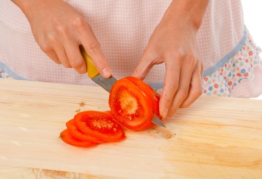 housewife preparing  tomato .Studio, white background. 